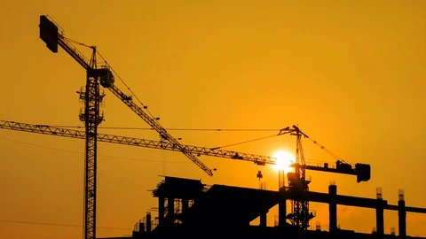 Silhouette Crane Working In Construction Site 4K Time Lapse (zoom out) Stock Footage 76983956