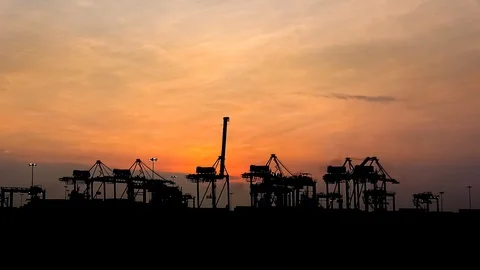 Silhouette of Cranes Loading And Unloading Container Onto Ship During Sunset Stock-Footage 95878527
