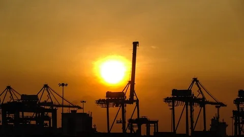 Silhouette of Cranes Loading And Unloading Container Onto Ship During Sunset Stock-Footage 95878597