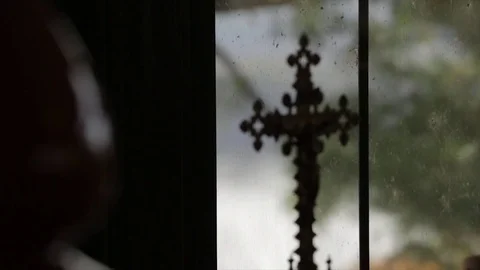 Silhouette cross in window with trees Stock Footage 83351141
