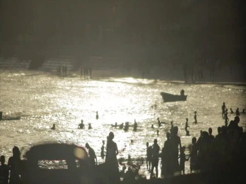 Silhouette crowds walk down the beach at sunset. Stock Footage 85012714