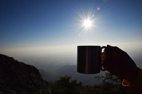 Silhouette cup at sunrise with mountain background Stock Photos