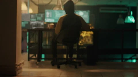 Silhouette of cyber criminal coding encryption to plant malware Stock Footage 230190845