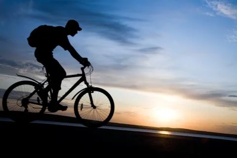 Silhouette of cyclists in motion Stock Photos