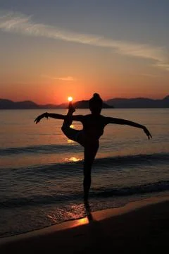 Silhouette of a dancer in the beach Stock Photos