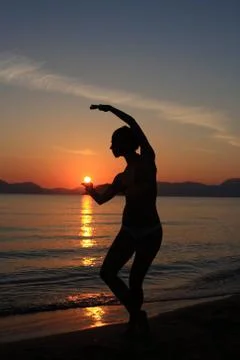 Silhouette of a dancer in the beach Stock Photos