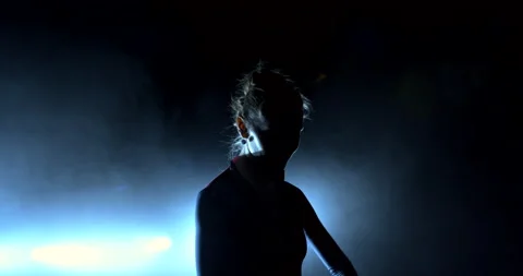 Silhouette of a dancer in the beams of a spotlight Видео 149754961