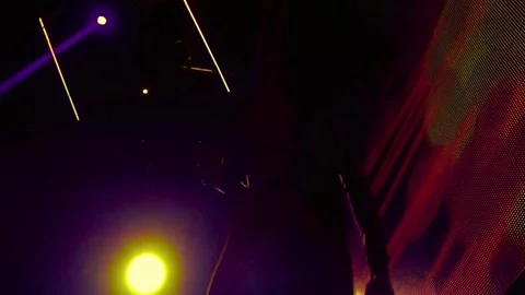 Silhouette dancer moves energetically on stage with colorful lights Stock-Footage 341969201