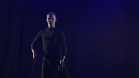 Silhouette of a dancer performing an element of bachata dance. Black background Stock Footage 137995267