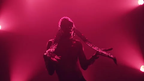 Silhouette of a dancer performing in magenta light Stock Footage 331597228