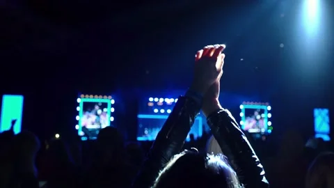 Silhouette of dancing hands in the light of spotlights at a concert Vídeos de archivo 223948671