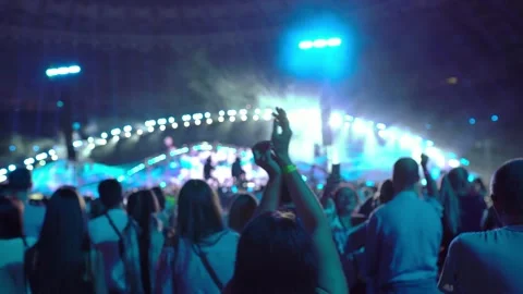 Silhouette of dancing hands in the light of spotlights at a concert Stock Footage 228648330