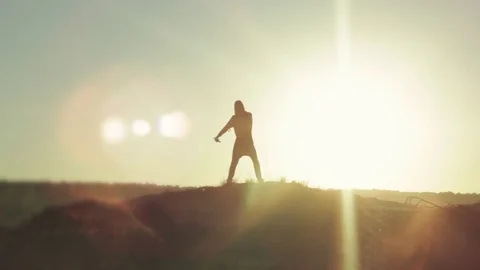 Silhouette of a dancing man at sunset Stock Footage 78154331