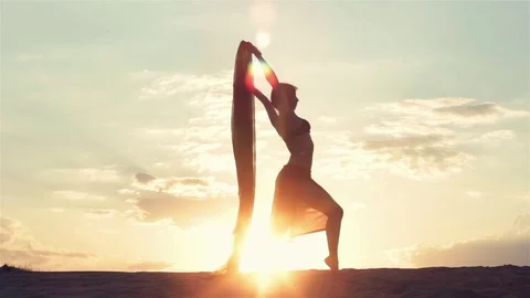 Silhouette of a dancing woman at sunset Stock Footage 77874780