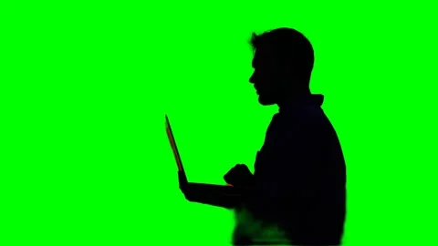Silhouette of developer male using laptop, working, green screen Stock Footage 275199362