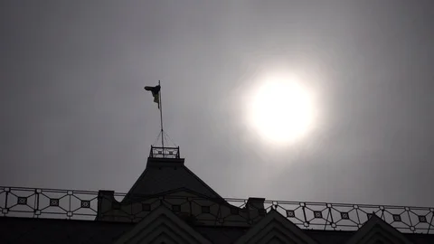 Silhouette of a developing flag against the background of the sun. Stock Footage 88711743
