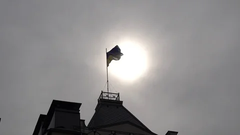 Silhouette of a developing flag against the background of the sun. Stock Footage 89939425
