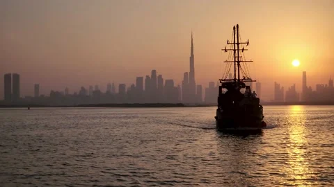 Silhouette of Dhow Cruise sailing on sea with skylines on background Stock Footage