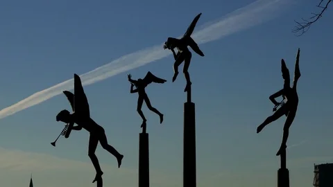 Silhouette of different angel statues with wings blue sky clouds in background Stock Footage 75044448