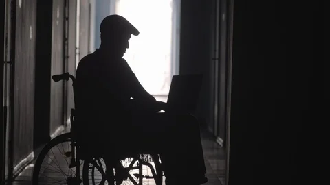 Silhouette of Disabled Man on Wheelchair Using Laptop and Smartphone Vidéo 100797449
