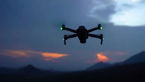 Silhouette of a drone during the sunset or sunrise, unmanned aerial vehicle Stock Footage 205879194