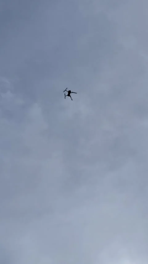 Silhouette of a drone flying in a cloudy sky 库存影片 332257945