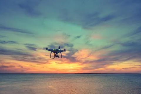 Silhouette of Drone Quad copter flying in sky Fotos Stock