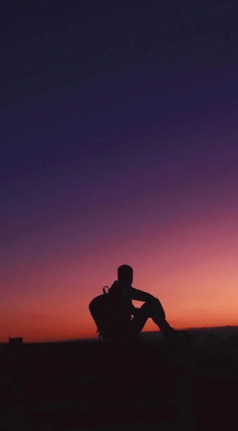 Silhouette at Dusk – A Moment of Reflection Stock Footage 303983309