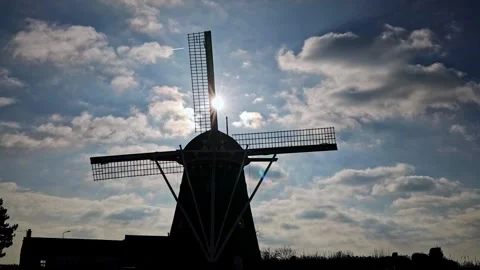 Silhouette of a Dutch windmill with slow moving clouds Video stock 300028134