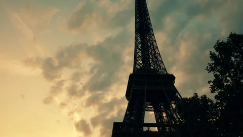 Silhouette of the Eiffel Tower against moving clouds in the evening in Paris Stock Footage 245354721