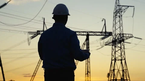 Silhouette electrical engineer, computer tablet, power towers. Concept energy Stock Footage 255085890