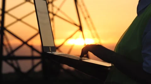 Silhouette electrical engineer, work computer tablet sunset, electric tower Stock Footage 242695566
