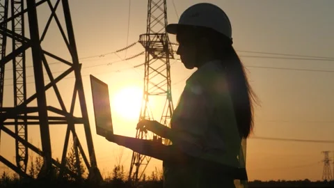 Silhouette electrical engineer, work laptop sunset, electric tower, electric Stock Footage 243096692