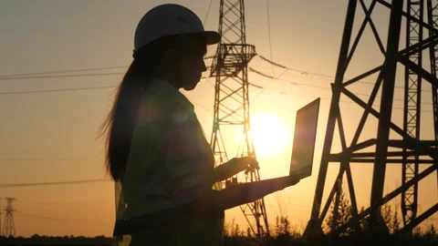 Silhouette electrical engineer, work laptop sunset, electric tower, high voltage Stock Footage 244545287