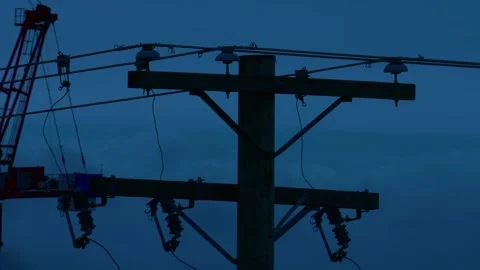 Silhouette of electrical utility pole and power lines at blue hour Video stock 331772771