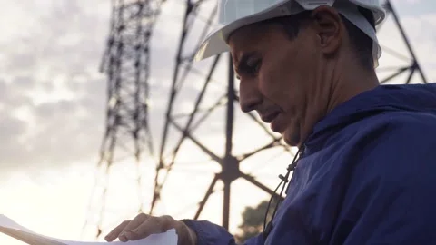 Silhouette of an electrician engineer working next to an electrical support Video stock 145467795