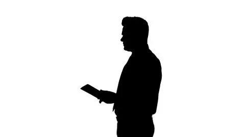 Silhouette Elegant young businessman using tablet while walking. 스톡 일러스트