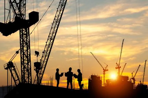 Silhouette of Engineer and worker team on building site, construction site Stock Photos