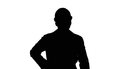 Silhouette Engineer in protective glasses and hat walking, taking on the phone. Stock Footage 99820925