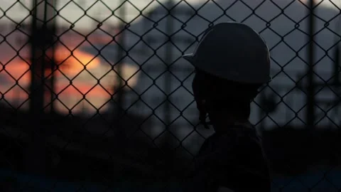 Silhouette engineer standing orders for construction crews and using phone. Stock Footage 165433970