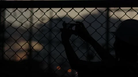 Silhouette engineer standing orders for construction crews and using phone Stock Footage 165434048