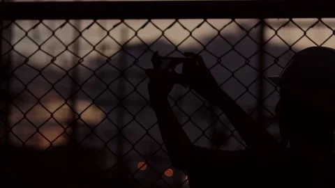 Silhouette engineer standing orders for construction crews and using phone. Stock Footage 165434053