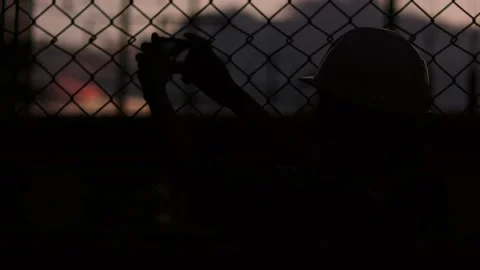 Silhouette engineer standing orders for construction crews and using phone. Stock Footage 165434110