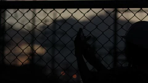 Silhouette engineer standing orders for construction crews and using phone. Stock Footage 165434135