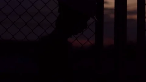 Silhouette engineer standing orders for construction crews and using phone. Stock Footage 165434145