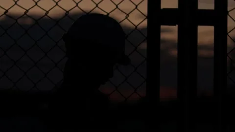 Silhouette engineer standing orders for construction crews and using phone. Stock Footage 165434431