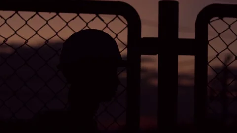 Silhouette engineer standing orders for construction crews and using phone. Stock Footage 165434496