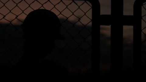 Silhouette engineer standing orders for construction crews and using phone. Stock Footage 165434497