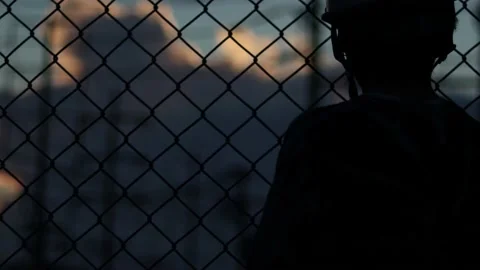 Silhouette engineer standing orders for construction crews and using phone. Stock Footage 165436308