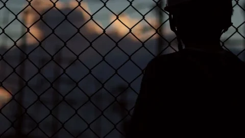 Silhouette engineer standing orders for construction crews and using phone. Stock Footage 165436386
